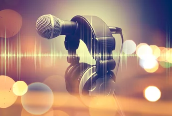 Foto auf Alu-Dibond Music background.Microphone and headphones.Live music and blurred stage lights © C.Castilla