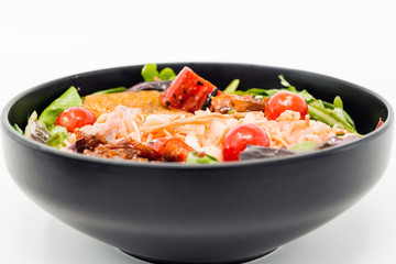 Delicious fresh salad with tomatoes, lettuce, eggplant, zucchini, cheese, parma ham and olive oil.