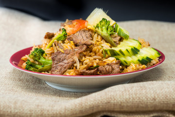 Homemade Chinese fried rice with vegetables and fried eggs