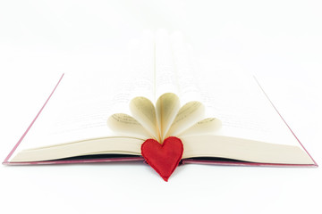 open book and a red heart next to the book
