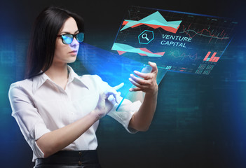 The concept of business, technology, the Internet and the network. A young entrepreneur working on a virtual screen of the future and sees the inscription: Venture capital