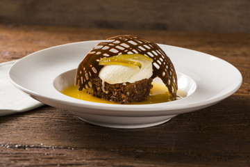 Chocolate cookie with ice cream and orange sauce