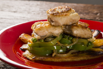 Tucunare fish in butter with green peppers and banana - Traditional Amazonian dish