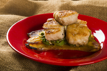 Tucunare fish in butter with green peppers and banana - Traditional Amazonian dish