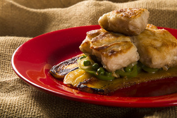Tucunare fish in butter with green peppers and banana - Traditional Amazonian dish
