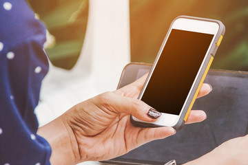 woman touch screen on smartphone with nature background.