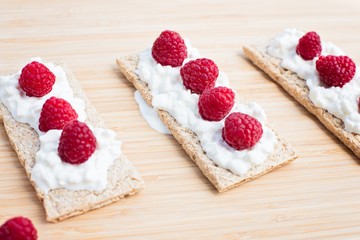 Crunchy rye-wheat bread with white cottage cheese and raspberries