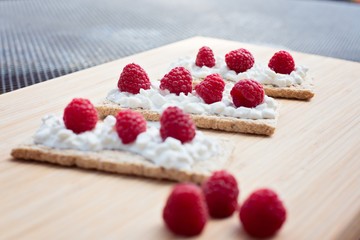 Crunchy rye-wheat bread with white cottage cheese and raspberries