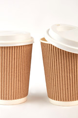 Closeup ripple paper cups. Disposable portable coffee mugs.