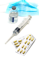 Syringe, capsules,and  medical mask bottle on white background