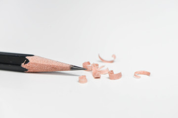 Pencil and scraps on the white table