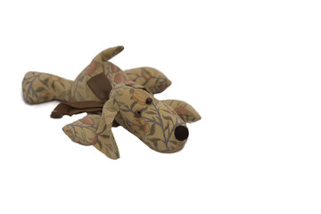 Dog doll lying on the floor ,Isolated on white background.