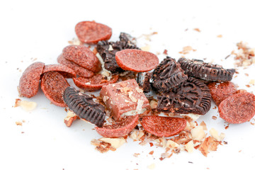 cereals with cocoa,cookies , chocolate and walnuts on white background