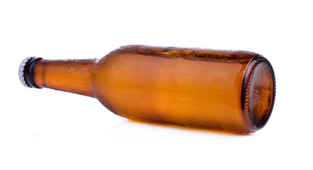 Bottle of beer with drops isolated on white background
