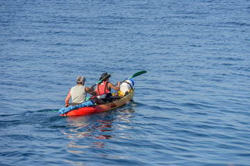man with woman canoeing in the sea