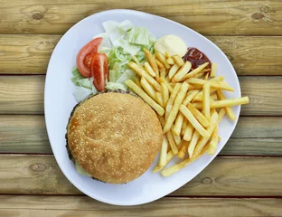 Tuinposter Plate with Cheeseburger french fries and sauces © vali_111