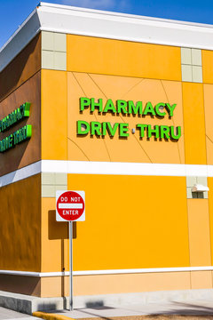 Bright green Pharmacy Drive Thru wall sign