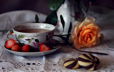 A cup of tea, a biscuit and a rose..