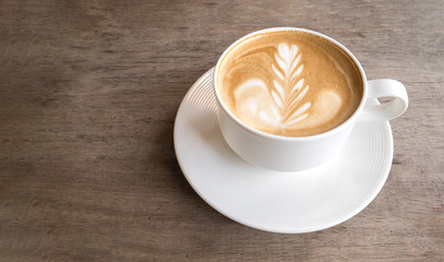 Hot coffee cappuccino latte art top view on wooden background