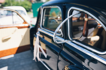 Black retro cars with wedding ribbon