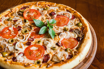 Delicious pizza with meat, cheese and mushrooms