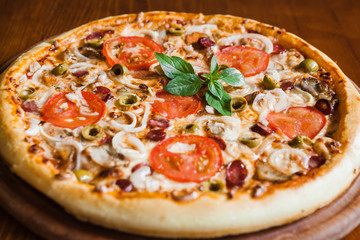 Delicious pizza with meat, cheese and mushrooms