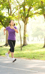 Asian woman running in the garden in the morning