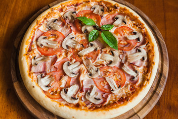Delicious pizza with meat, cheese and mushrooms