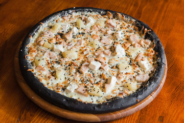 Delicious pizza with meat, cheese and mushrooms