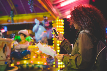 young woman beautiful using smart phone outdoor in the city night life - technology, social network, communication concept