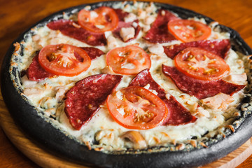 Delicious pizza with meat, cheese and mushrooms