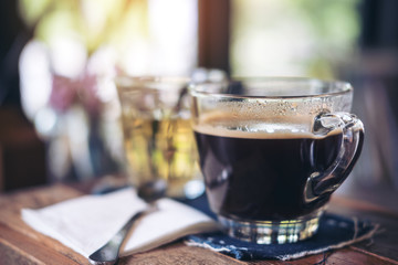 Closeup image of cups of hot coffee and tea on vintage wooden table in cafe