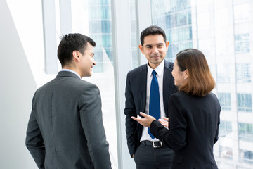 Business colleauges talking in building hallway