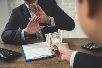 Businessman rejecting money