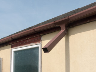 brown steel gutter on garage