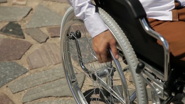 Close up of young disabled man in wheelchair
