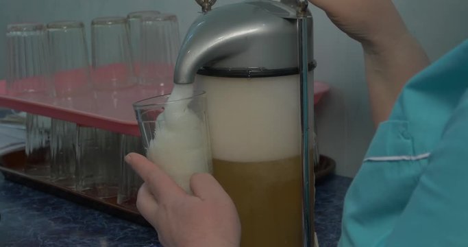 Woman make oxygen cocktail with device for oxygen scum. Oxygen cocktail for children. Woman make oxygen cocktail with device for oxy scum