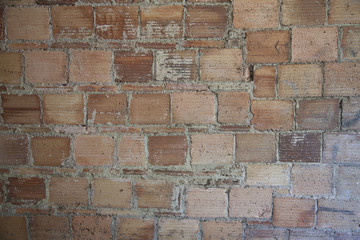 Abstract reddish bricks background gritty texture.