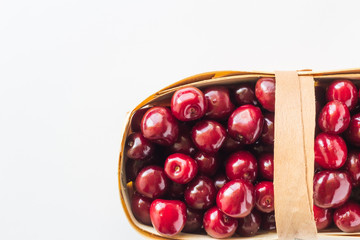 Berries in a basket, cherry on a white background.