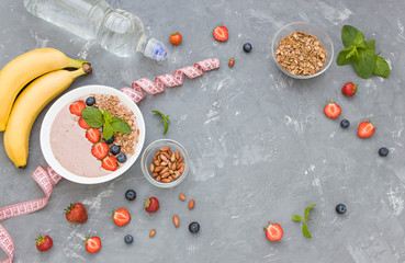 Diet concept flat lay porridge, nuts, fresh berries and bottle of water. Top view.  Copy space