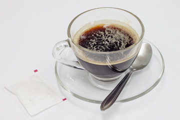 Coffee in the cup whit sugar on transparent glass.