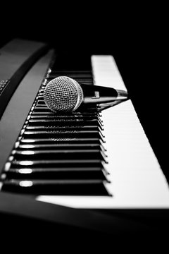 microphone on piano, black and white. music background