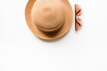 Summer straw hat beach and sunglasses on a white background with place for text