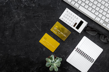 online purchasing with credit cards and notebook dark manager desk background top view mock-up