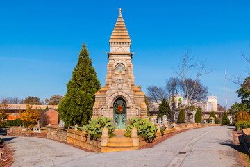 Luxury crypt on the crossroad and tombstones on the Oakland Cemetery in sunny autumn day, Atlanta,...