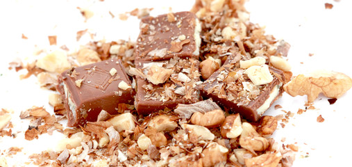 close up a  milk chocolate bar and walnuts  on white background