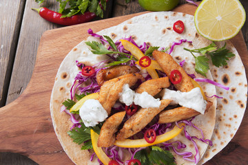 Chicken fajitas vegetables and sauce on a Mexican tortilla tacos