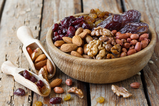 Mix of dried fruits and nuts in a wooden bowl