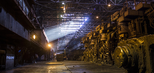 Iron and steel works factory with sun beam