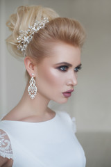 portrait of beautiful blonde bride with fashion hairstyle and make-up